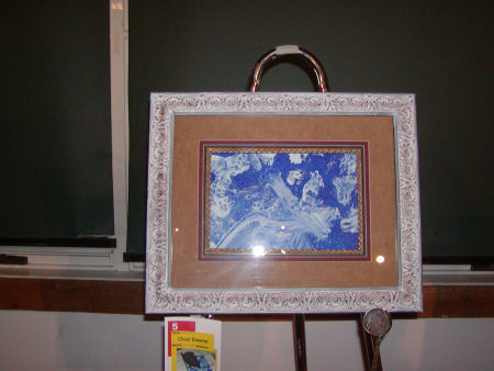 Painting with white puffs on blue background.