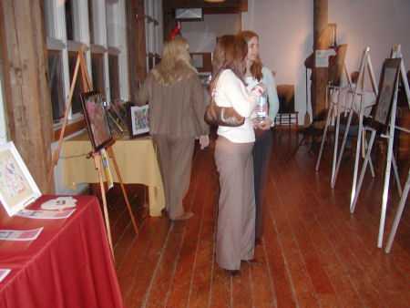 A couple of women viewing the paintings.